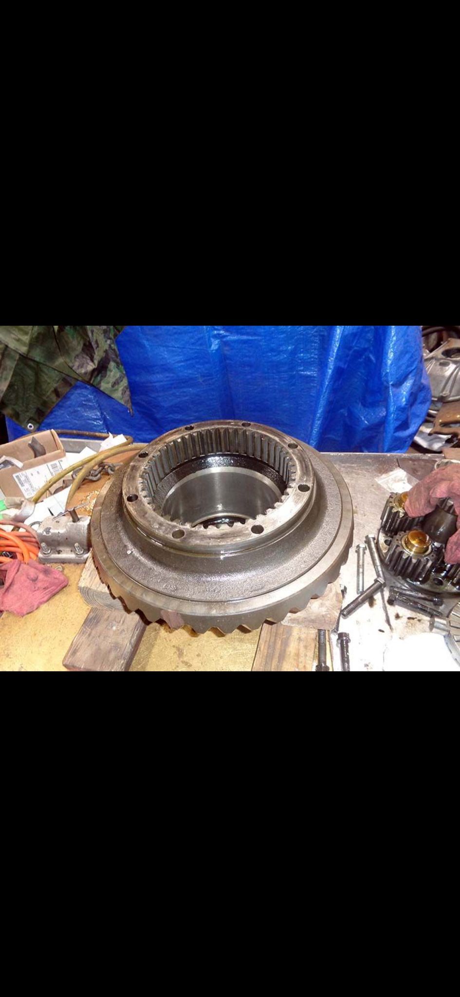 Transmission case and parts on a workbench with tools